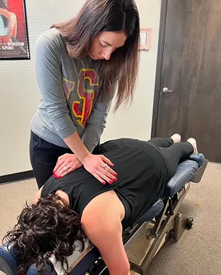 Chiropractor Cedar Rapids IA Sadie Wessels Adjusting Patient